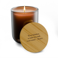 Scented soy candle in a frosted burnt amber glass jar with a bamboo lid and the Aisopos quote "No act of kindness, no matter how small, is ever wasted."